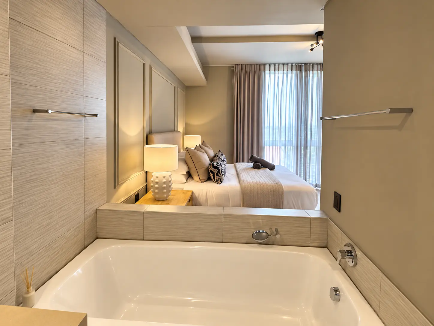 Deep bathtub looking through to the bedroom